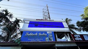 A building with a blue signboard for Fabtech India, located on Dharapur Road in Guwahati. - Assam Inn Grand  (Guwahati)