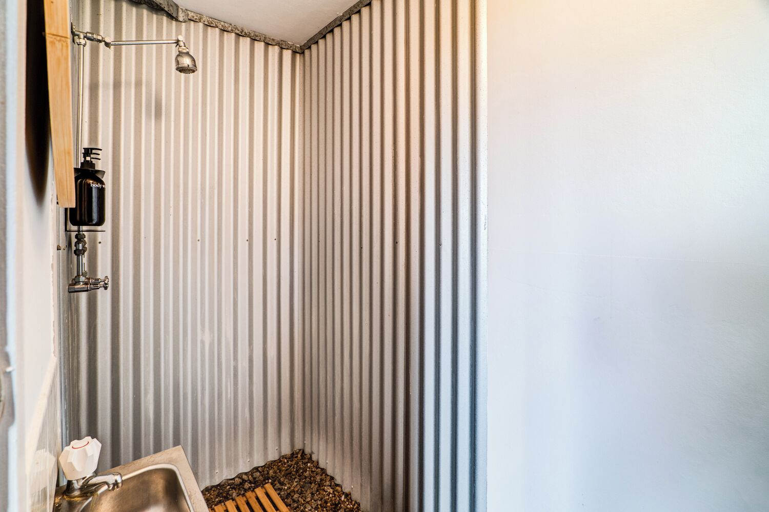 A bathroom with a shower, a sink, and a toilet.