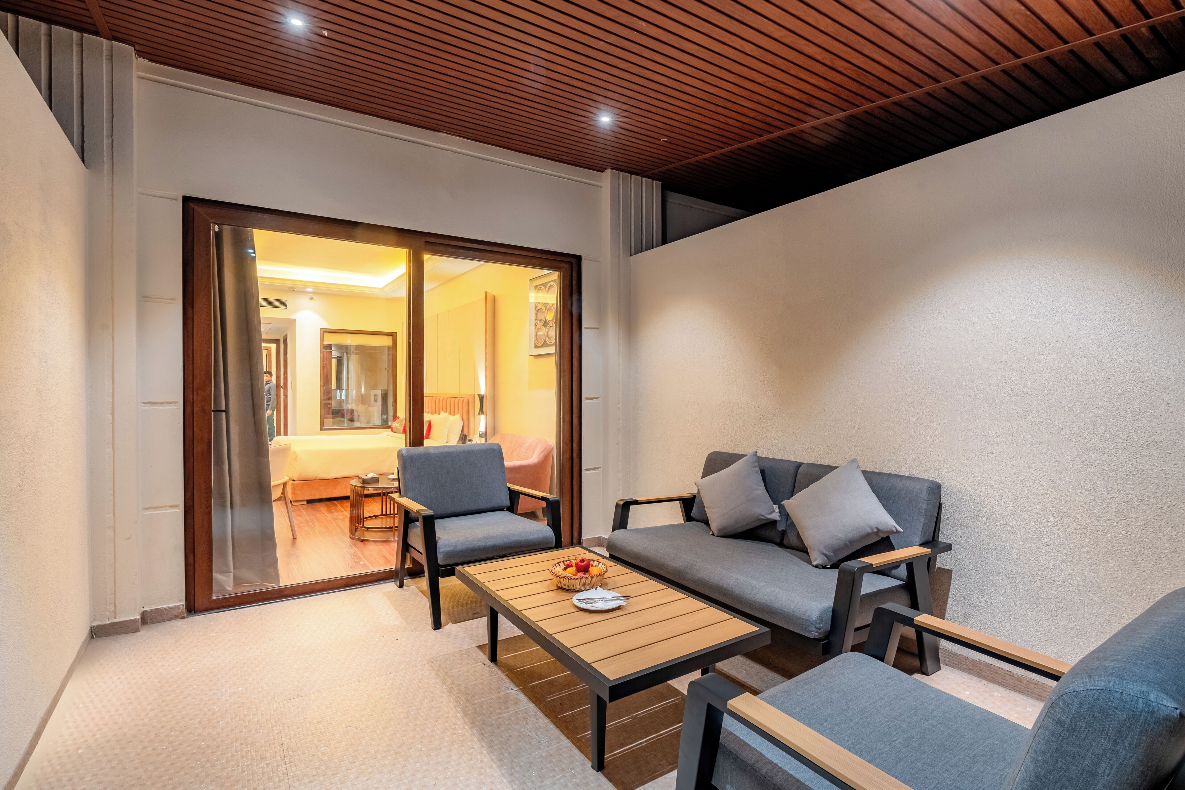 A modern living room with a sofa, armchairs, and a coffee table.