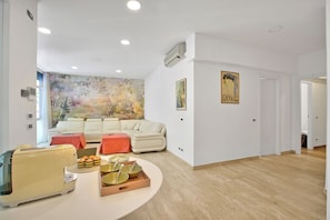 Family Apartment, Multiple Bedrooms (Residenza Albachiara) | Living area | 21-inch flat-screen TV with cable channels