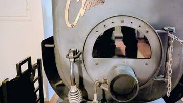A vintage-style oven with the word 'Chic' on it, a metal handle, and a chain.