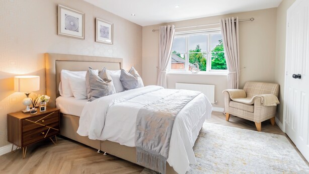 A bedroom with a bed, nightstand, chair, window, and artwork on the wall. -  Birmingham Stay Free Parking for Families Travellers Professionals M6 (Birmingham)