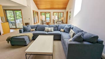 Signature House, 5 Bedrooms, Patio, Lake View | Living room | 50-inch Smart TV with digital channels, fireplace, foosball