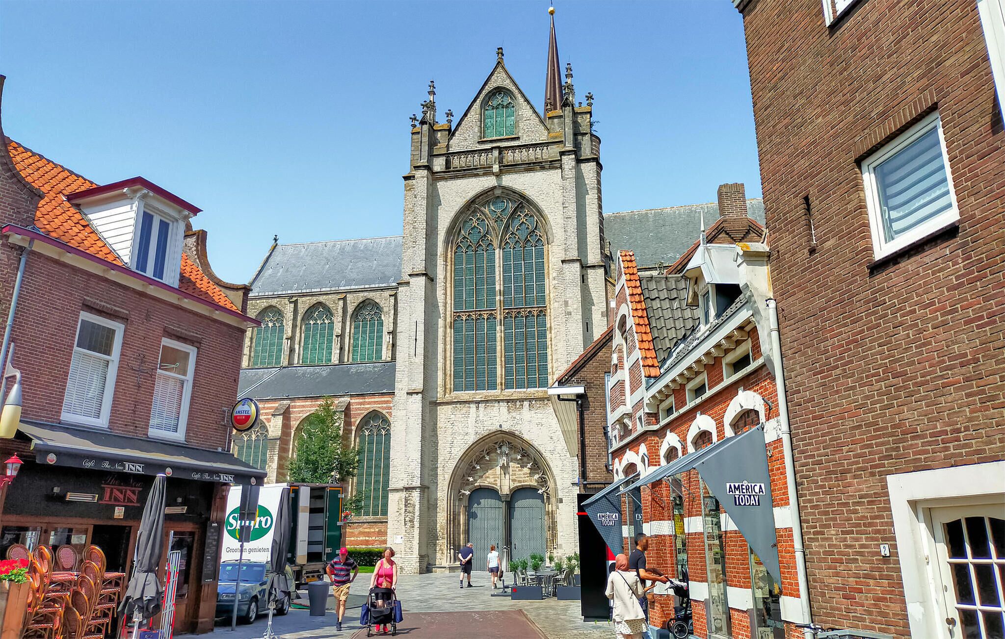 A historic church with a tall tower and large stained glass windows.