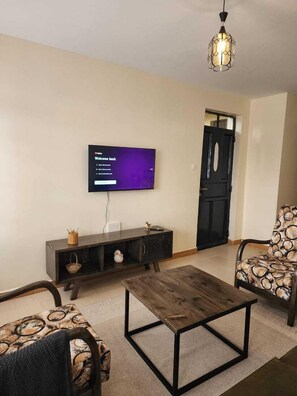 Family Apartment, Balcony, City View | Living area | 32-inch Smart TV with digital channels