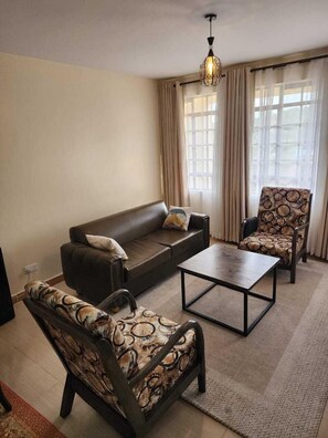 Family Apartment, Balcony, City View | Living area | 32-inch Smart TV with digital channels