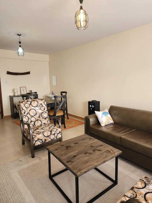 Family Apartment, Balcony, City View | Living area | 32-inch Smart TV with digital channels