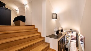 A staircase leading to a kitchen area with a dining table and chairs. - Idyllia | Luxury home with terrace (Rome)