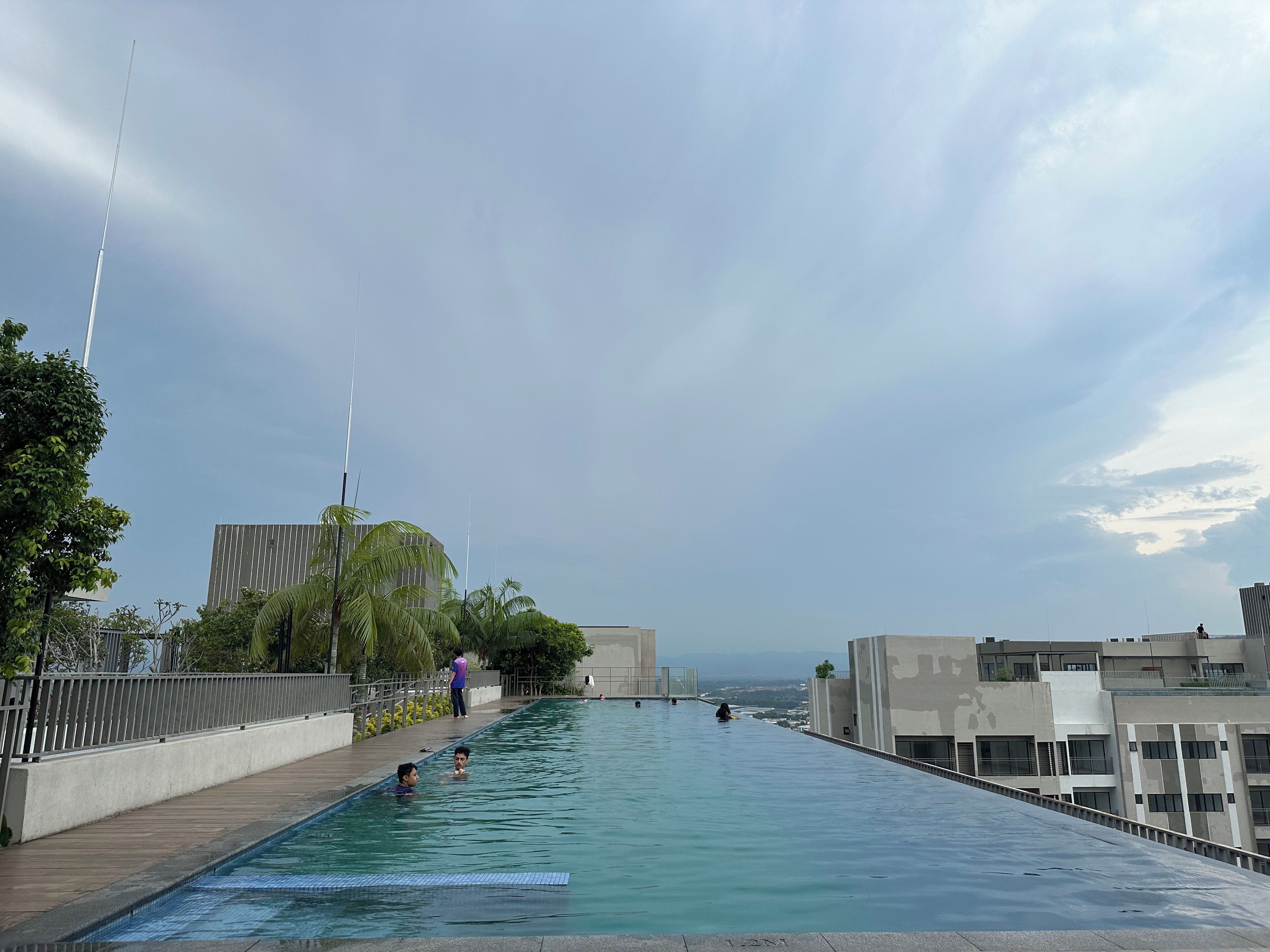 A rooftop infinity pool with a clear view of the city skyline.