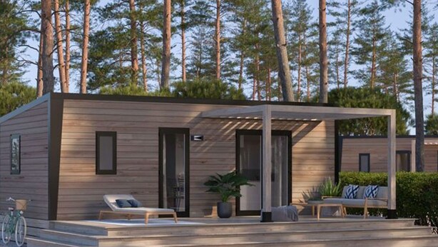 A modern cabin with a covered patio, a bicycle, and a view of tall pine trees. - Cozy mobile home for 4 with terrace (Granges-Aumontzey-Aumontzey)