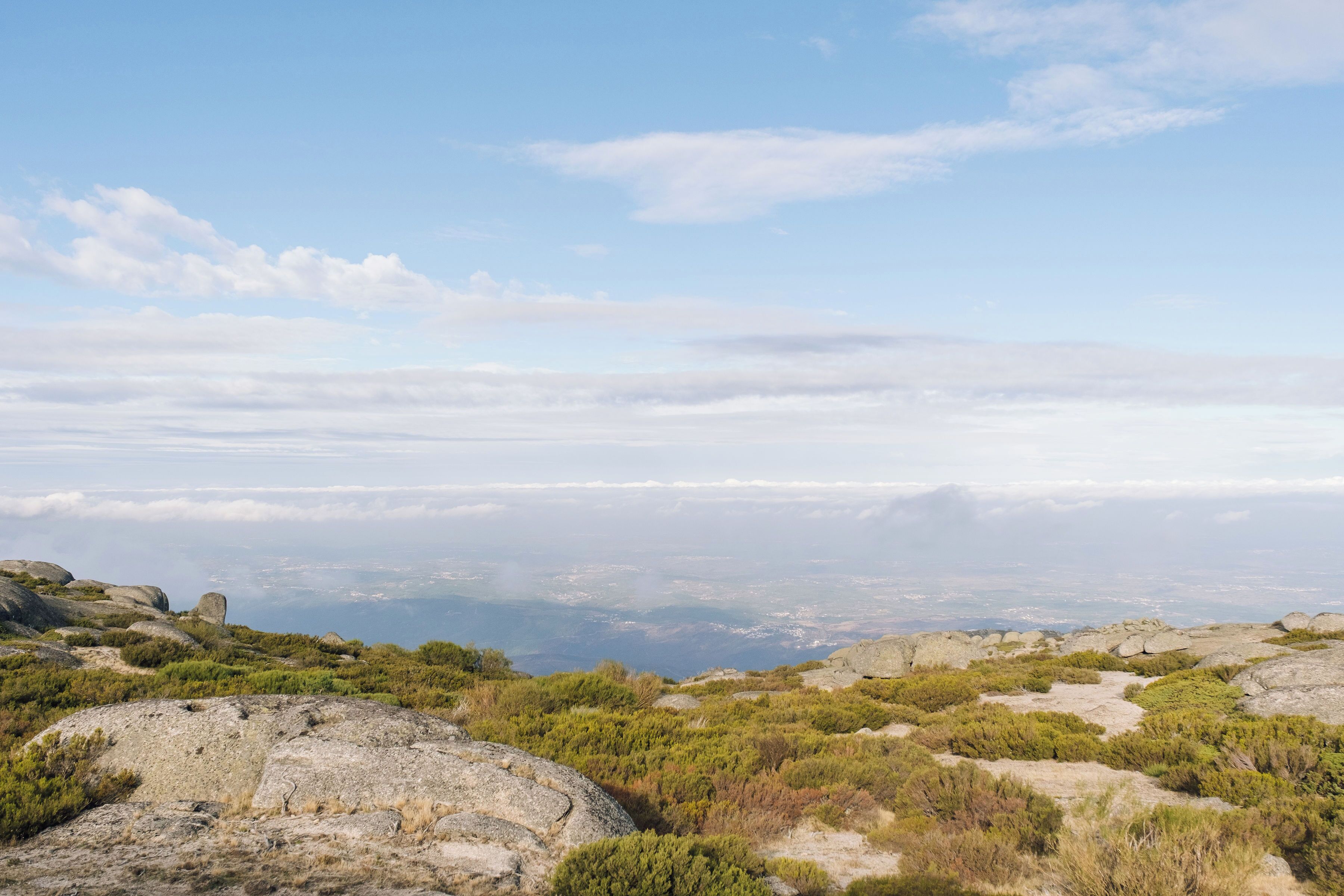 A mountainous landscape with rocky terrain and sparse vegetation.
