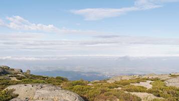 A mountainous landscape with rocky terrain and sparse vegetation.