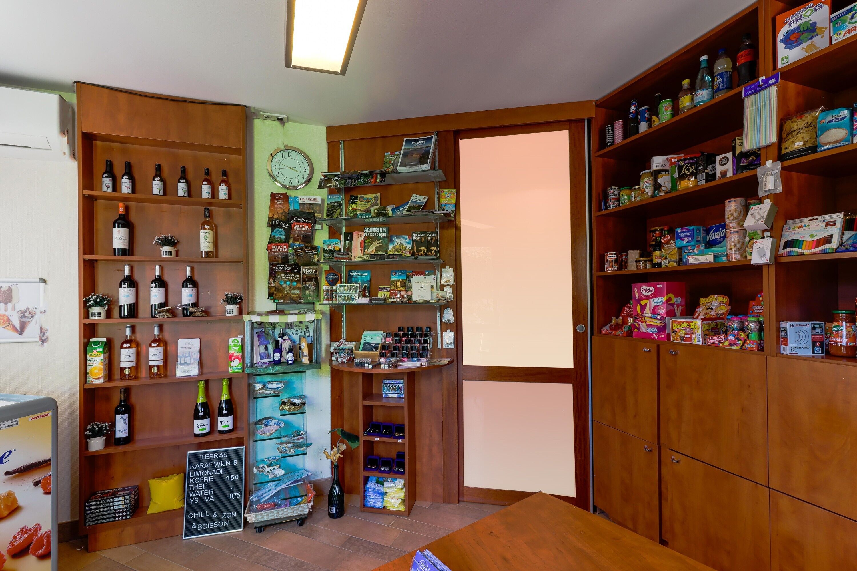 A store with shelves of wine, snacks, and other items.