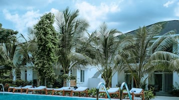 Outdoor pool, pool umbrellas, lifeguards on site