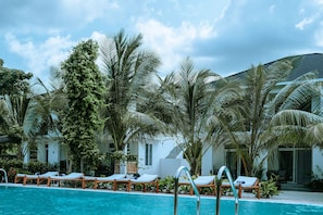 Outdoor pool, pool umbrellas, lifeguards on site
