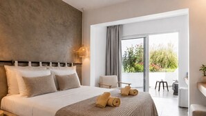 A modern bedroom with a large bed, a view of the outdoors, and a balcony with seating. - Rhodea Mar (Rhodes)