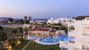 A resort with a pool, outdoor seating, and a view of the sea. - Rhodea Mar (Rhodes)