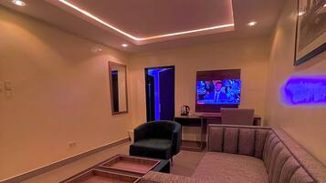 A modern living room with a sectional sofa, a small table, and a television.