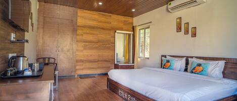 A bedroom with a wooden ceiling, a bed with white bedding, a ceiling fan, and an air conditioning unit.