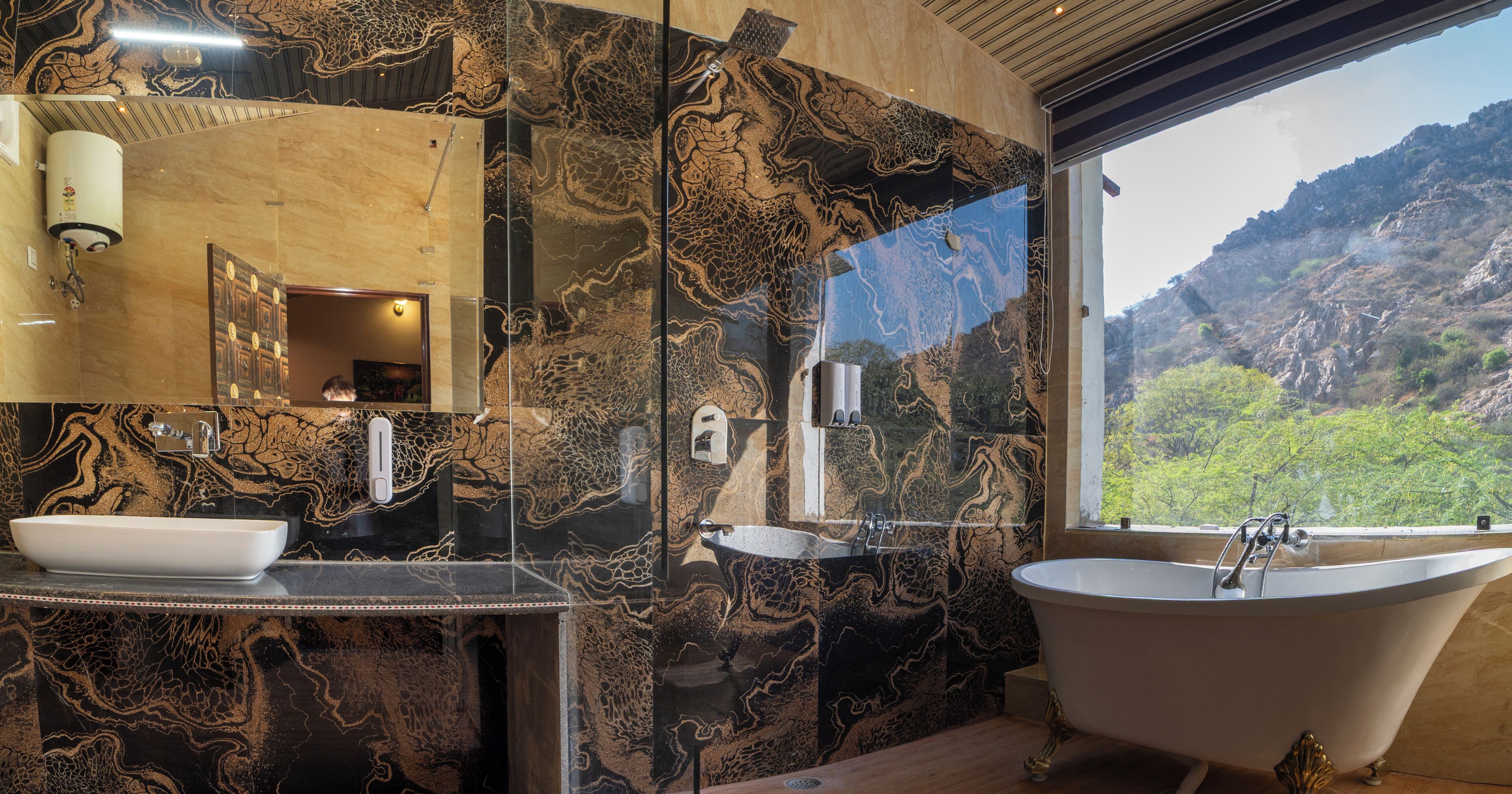 A bathroom with a bathtub, a sink, and a large mirror.