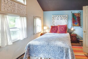 A bedroom with a bed, curtains, a nightstand, a lamp, a wall art piece, and a door. - Spacious Nashville Retreat w/ Yard: WFH Friendly! (Nashville)