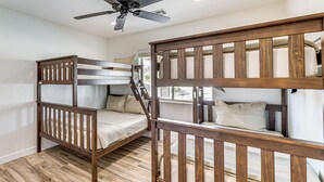 A room with two bunk beds, a ceiling fan, and a window. - Fully Furnished Poolside Oasis 5 Mi to Lake Havasu (Lake Havasu City)