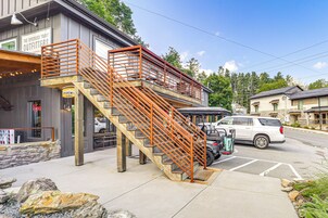 A two-story building with a wooden staircase and orange railings.