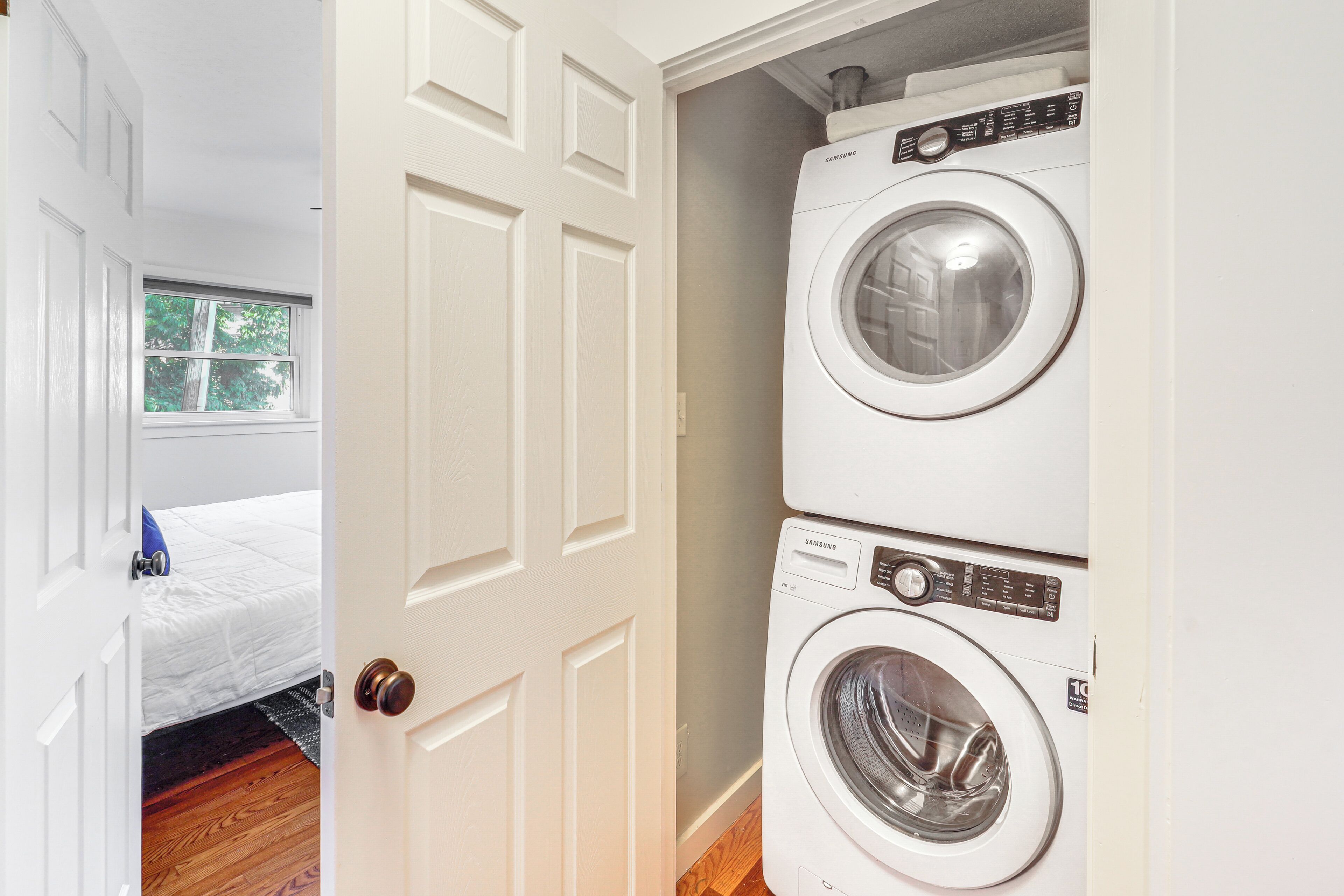 A laundry room with two stacked front-loading washing machines.