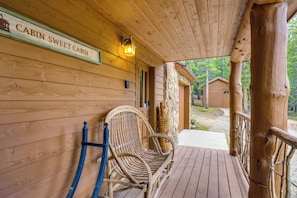 A wooden cabin with a porch, a sign reading "Cabin Sweet Cabin," and two wicker chairs. - Hot Tub + Game Room: Fairplay Cabin Near Hiking (Fairplay)