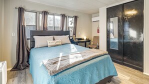 Une chambre à coucher avec un lit, un bureau et une armoire.