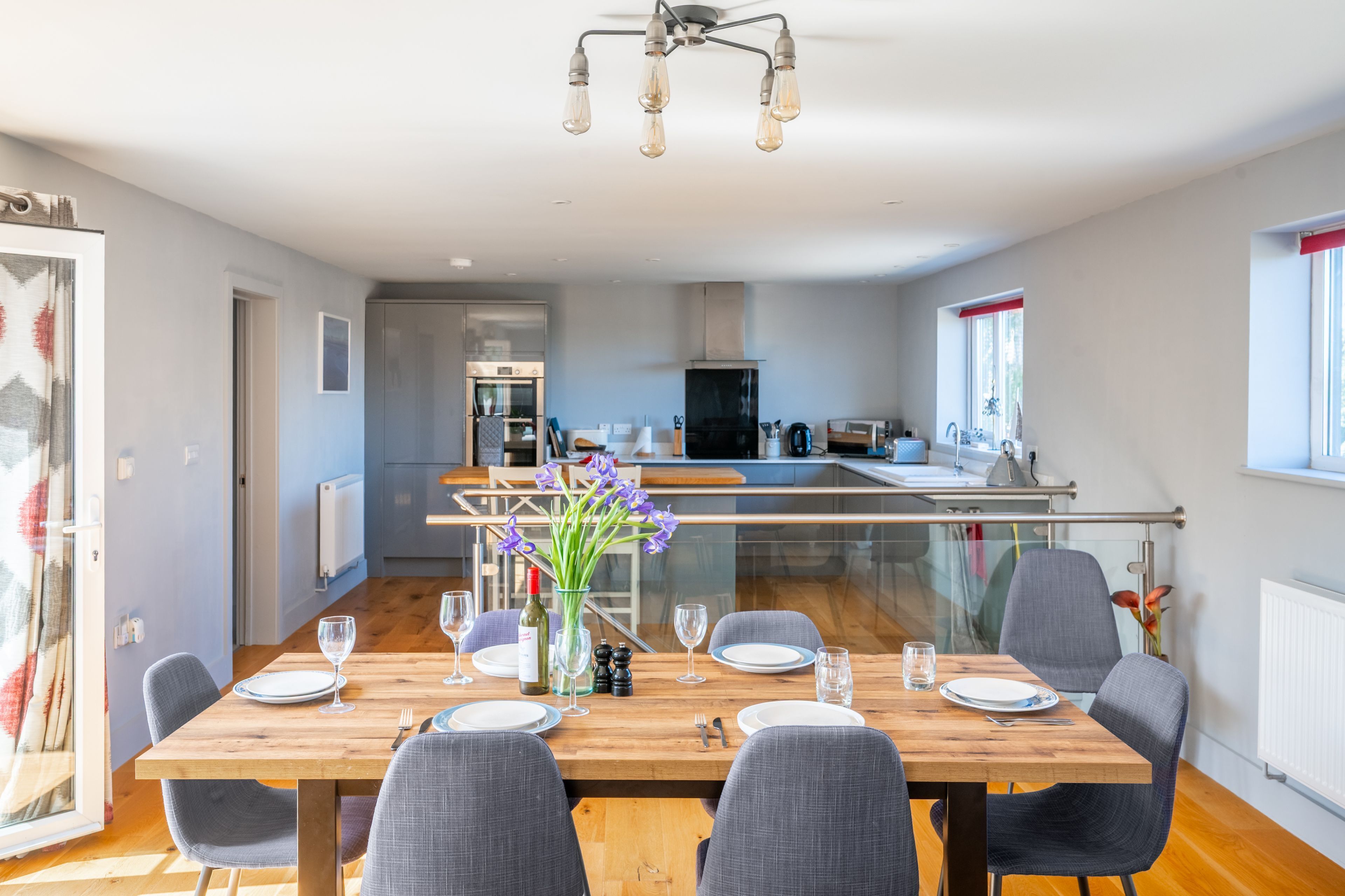 A modern kitchen with a dining area.