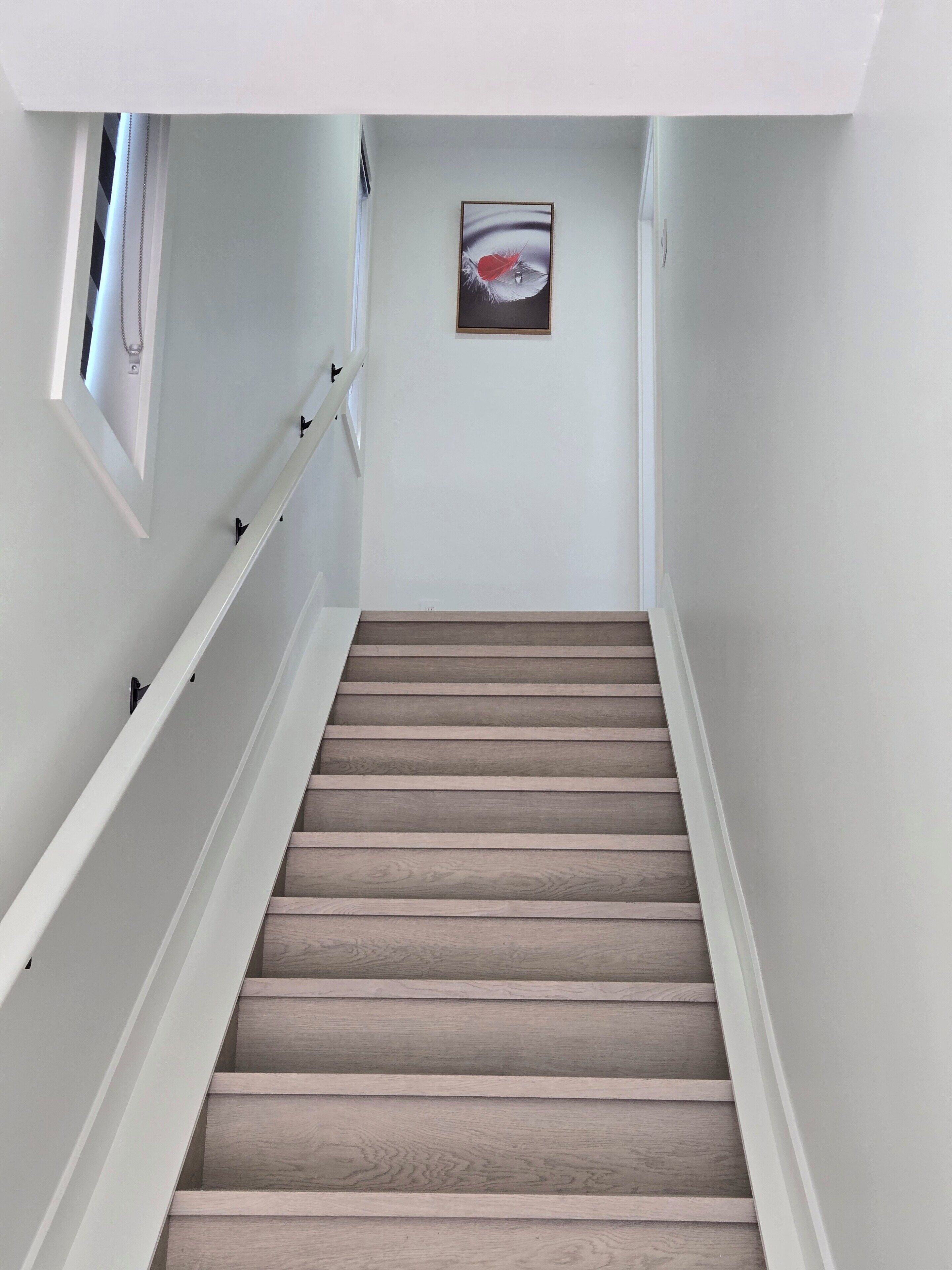 A staircase with wooden steps and white railings.