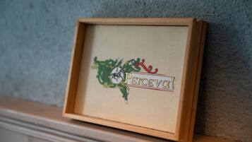 A framed sign with the word 'Perceval' and a decorative emblem.