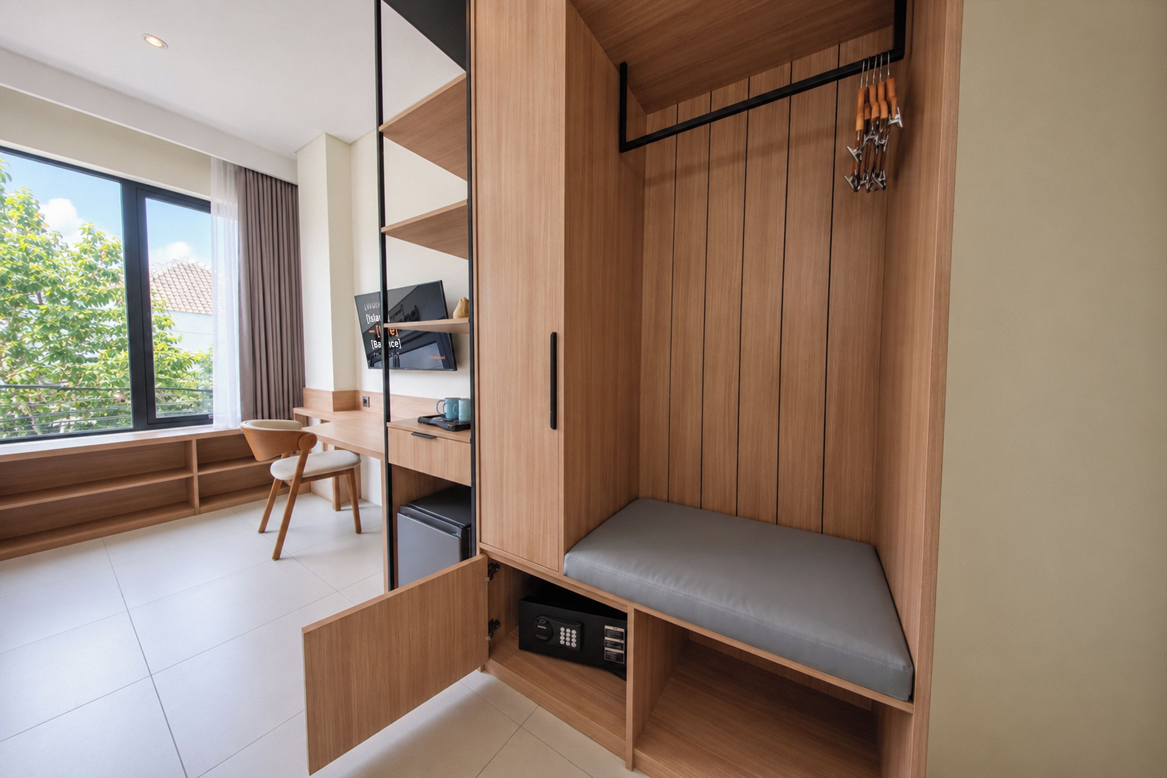 A modern room with a built-in bench, a desk, and a TV.