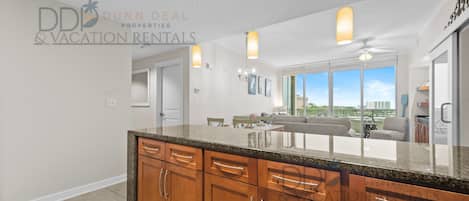 A modern kitchen with wooden cabinets and a granite countertop.