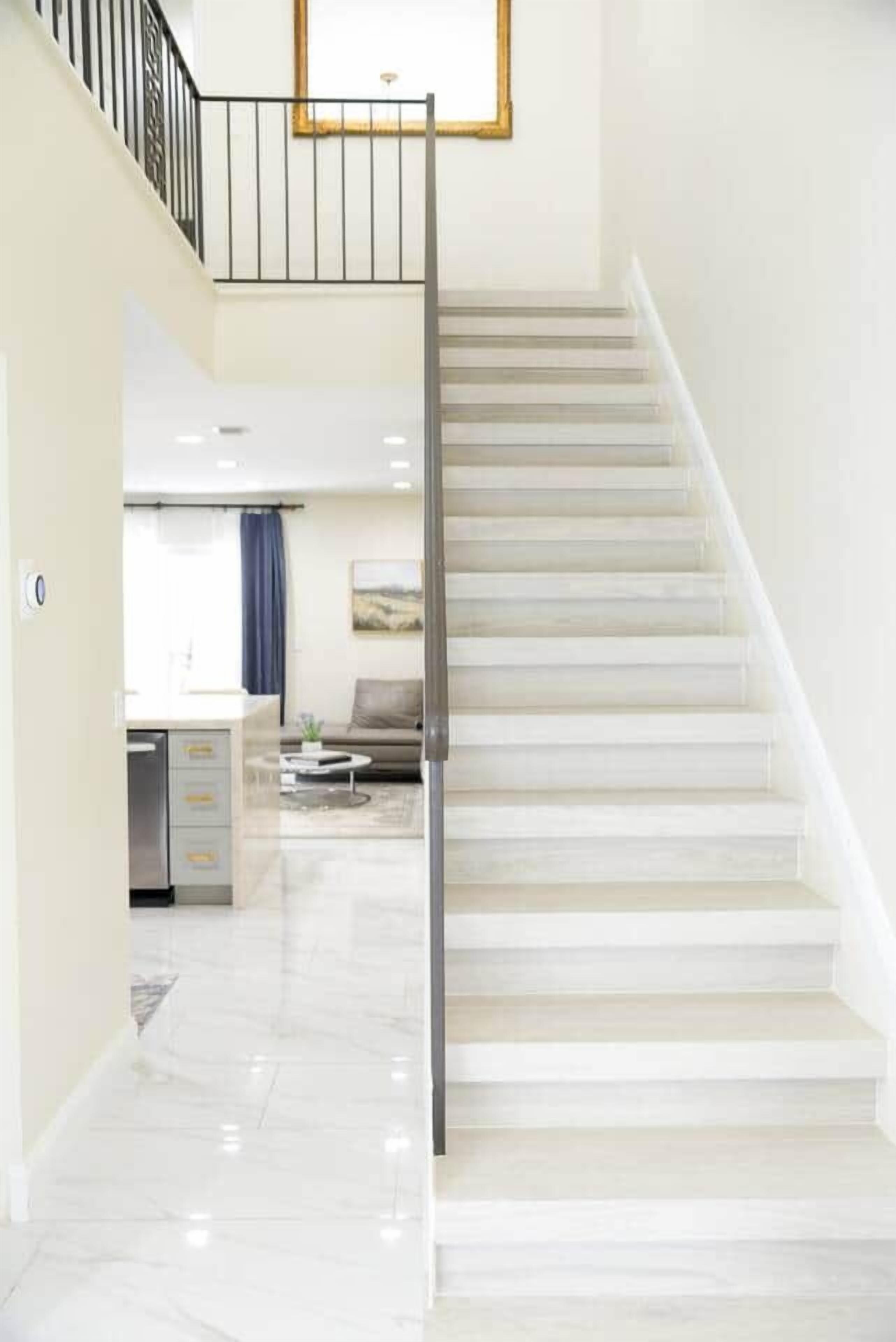 A modern interior with a staircase leading to an upper floor.