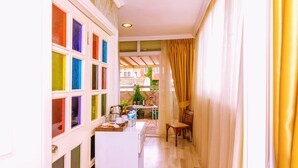A narrow hallway with a kitchen area on the left, featuring colorful window panes. - Walnut Shell Hotel Sultanahmet (Istanbul)