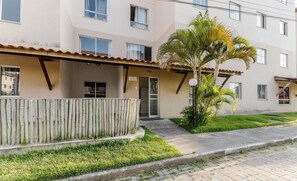 A multi-story residential building with a flat roof, a wooden fence, and a well-maintained lawn. - Apartment w/ Pool 350m From the Beach Vjgm0102 (Ilhéus)