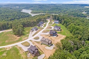 An aerial view of a residential area with houses, roads, and a river.