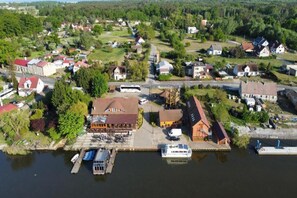 An aerial view of a riverside town with a dock, boats, and buildings. - Double room with breakfast in Świnoujście (Świnoujście)
