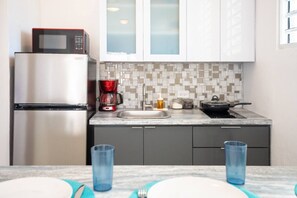 Fridge, microwave, stovetop, coffee/tea maker