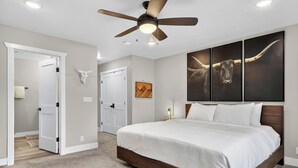 A bedroom with a large bed, a ceiling fan, and artwork on the wall. - Spacious Pet Friendly Mountain Townhome | Game Room + Near Slopes (Brian Head)