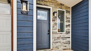 A front door with a stone facade, a mailbox, and a number '25' above the door. - Spacious Pet Friendly Mountain Townhome | Game Room + Near Slopes (Brian Head)
