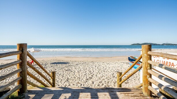 A wooden beach entrance with a lifeguard sign, sandy beach, and ocean view. - 2BR apt W/suite 100m Bombas Beach Ror0001 (Bombinhas)