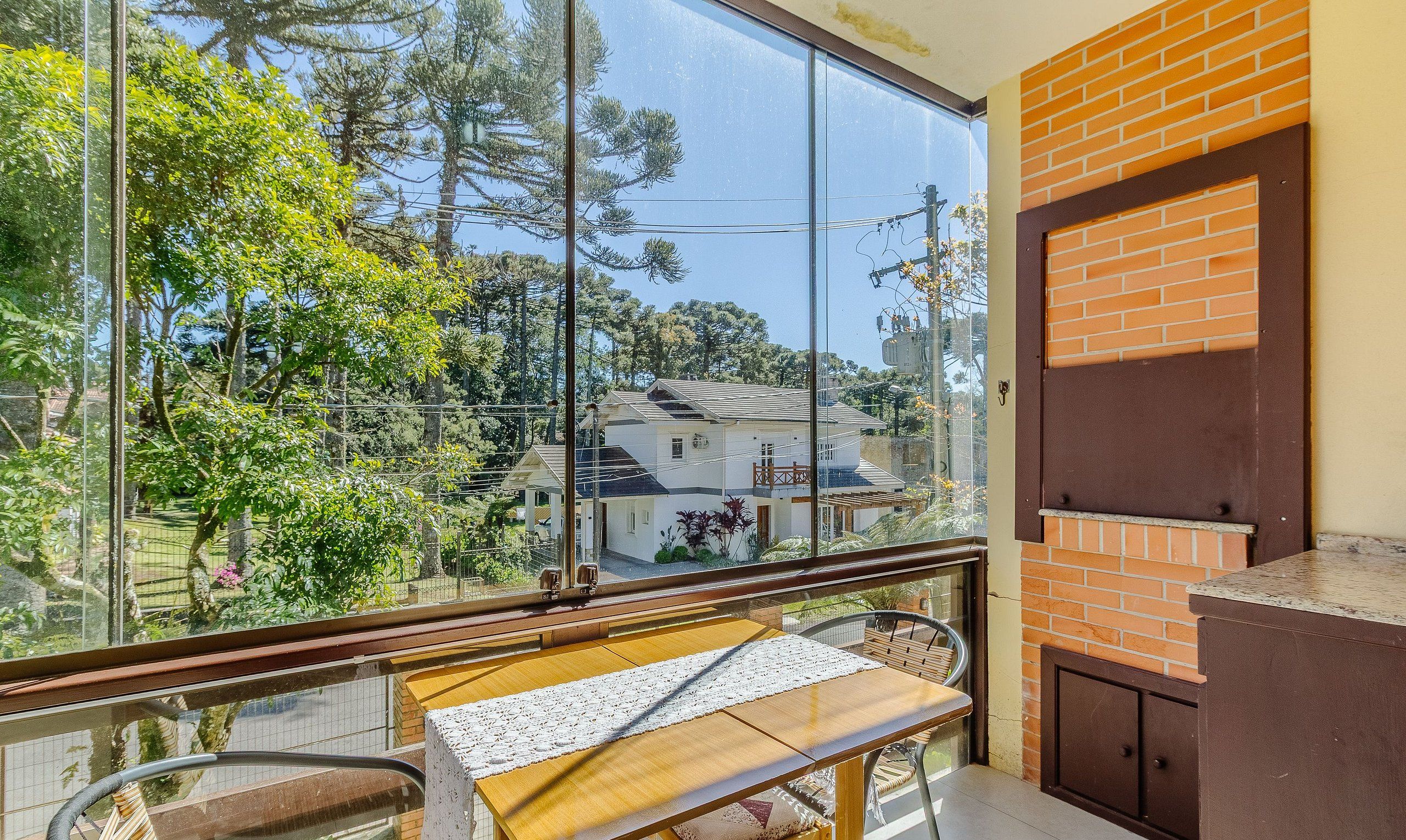 A balcony with a view of a house and trees.