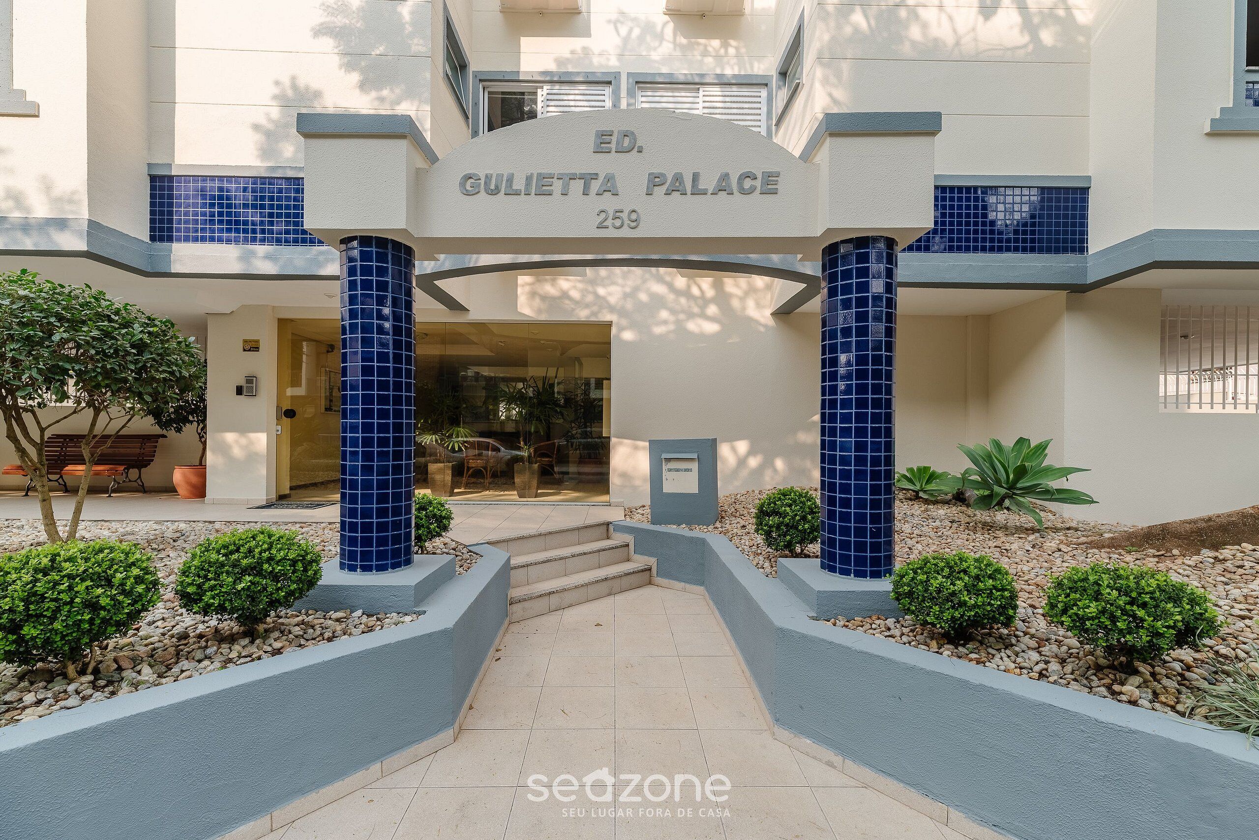 The entrance to Ed. Giulietta Palace, featuring a tiled pathway, blue pillars, and a sign with the address 259.