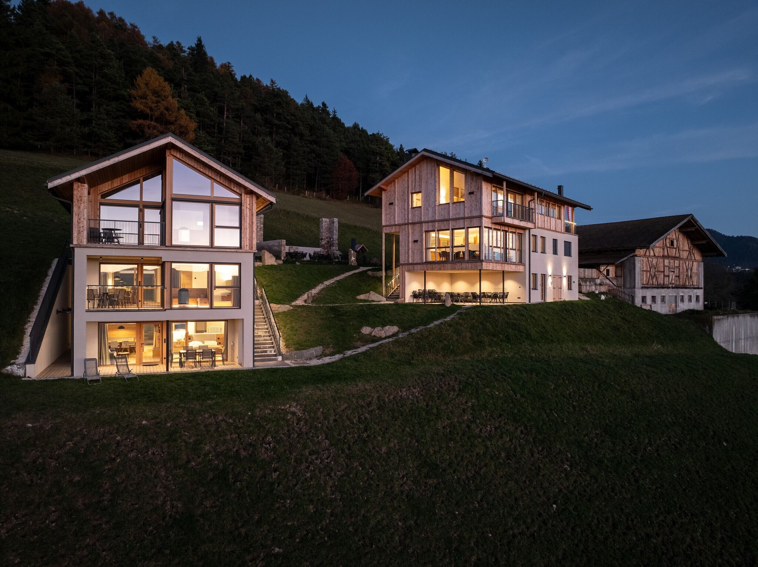 A modern two-story house with a balcony, a staircase, and a dining area.