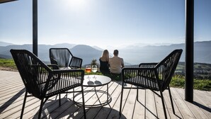 A couple sitting at a table with a view of mountains.