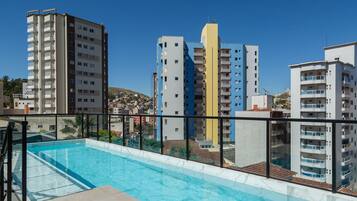 A rooftop pool with a clear view of surrounding high-rise buildings.