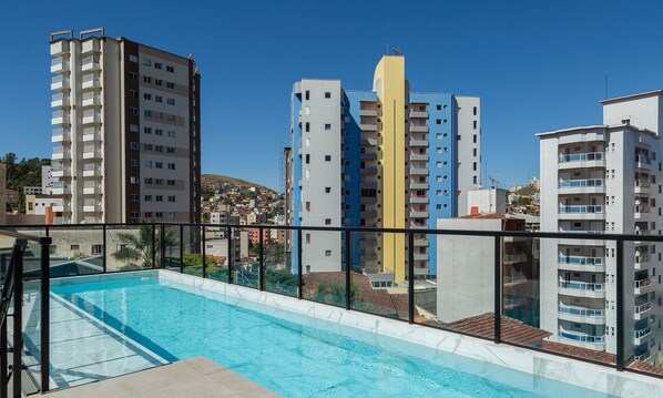 A rooftop pool with a clear view of surrounding high-rise buildings.